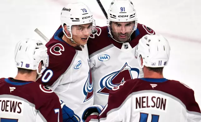 Colorado Avalanche's Sam Malinski (70) celebrates after scoring during the first period of an NHL hockey game against the Pittsburgh Penguins in Pittsburgh, Tuesday, March 24, 2026. (AP Photo/Gene J. Puskar)