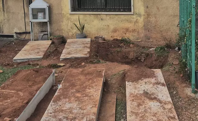 A grave, background, dug by Israeli forces landed overnight late Friday, searching for Israeli co-pilot Ron Arad who was captured and then went missing after his fighter jet crashed over south Lebanon in 1986, in Nabi Chit village, eastern Lebanon, Saturday, March 7, 2026. (AP Photo/Ali Salem)