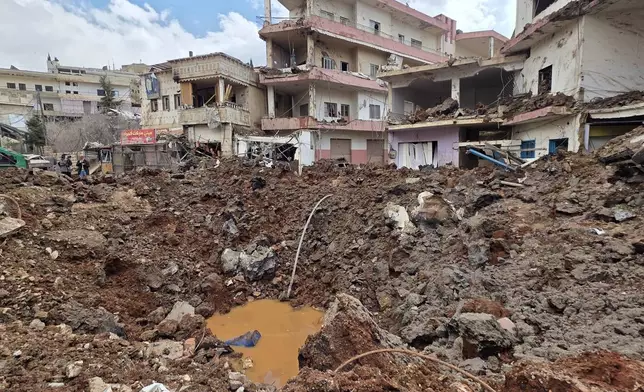 A huge crater left by an Israeli airstrike in the village of Nabi Chit, eastern Lebanon late Friday, March 6, 2026, where Israeli forces landed overnight and dug a grave in a cemetery searching for Israeli co-pilot Ron Arad who was captured and then went missing after his fighter jet crashed over south Lebanon in 1986. (AP Photo/Ali Salem)