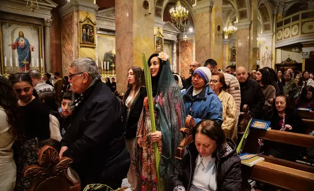 Catholic faithfuls attend a Palm Sunday mass at the Monastery of Saint Saviour in Jerusalem's Old City Sunday, March 29, 2026. (AP Photo/Mahmoud Illean)