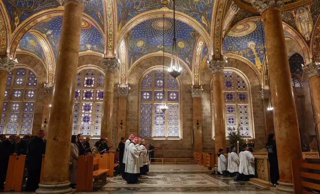 Faithful attend a prayer service in the Church of All Nations, held by Cardinal Pierbattista Pizzaballa, the Latin Patriarch of Jerusalem, to mark Palm Sunday in Jerusalem, Sunday, March 29, 2026. (Ammar Awad/Pool Photo via AP)