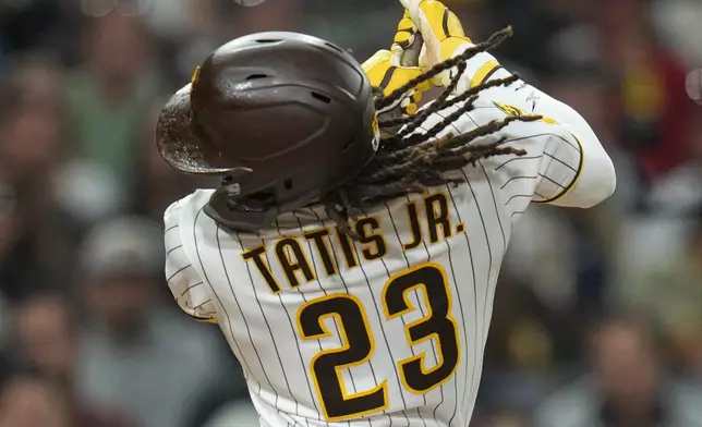 San Diego Padres' Fernando Tatis Jr. swings while batting during the fourth inning of a baseball game against the San Francisco Giants Monday, March 30, 2026, in San Diego. (AP Photo/Gregory Bull)