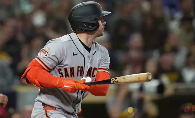 San Francisco Giants' Patrick Bailey watches his RBI single during the fourth inning of a baseball game against the San Diego Padres Monday, March 30, 2026, in San Diego. (AP Photo/Gregory Bull)