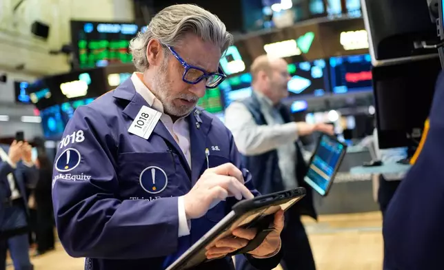 John Romolo works on the floor at the New York Stock Exchange in New York, Wednesday, March 25, 2026. (AP Photo/Seth Wenig)