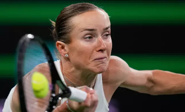 Elina Svitolina, of Ukraine, returns a shot against Elena Rybakina, of Kazakhstan, during a semifinal match at the BNP Paribas Open tennis tournament, Friday, March 13, 2026, in Indian Wells, Calif. (AP Photo/Mark J. Terrill)