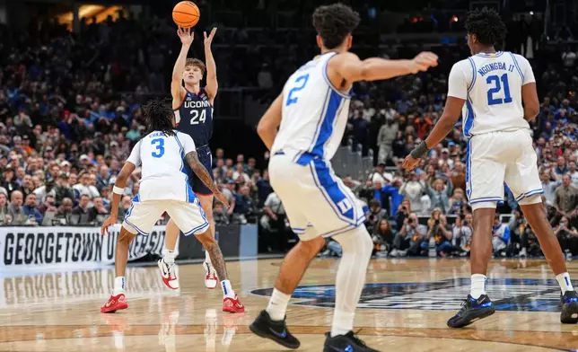 UConn guard Braylon Mullins (24) scores the winning basket during the second half against Duke in the Elite Eight of the NCAA college basketball tournament, Sunday, March 29, 2026, in Washington. (AP Photo/Abbie Parr)