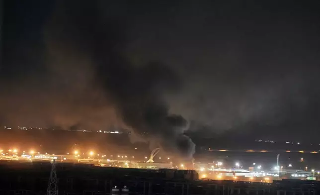 Smoke rises after an explosion at the airport in Irbil, Iraq, late Wednesday, March 11, 2026. (AP Photo/Leo Correa)