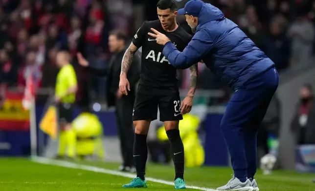Tottenham's head coach Igor Tudor, right, gives instructions to Tottenham's Pedro Porro during the first leg of the Champions League round of 16 soccer match between Atletico Madrid and Tottenham in Madrid, Spain, Tuesday, March 10, 2026. (AP Photo/Jose Breton)