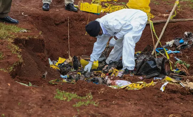 Directorate of Criminal Investigations (DCI) forensic staff inspect the scene of a mass grave where 33 bodies were exhumed at a cemetery in Kericho, Western Kenya Thursday, March 26, 2026. (AP Photo/Andrew Kasuku)