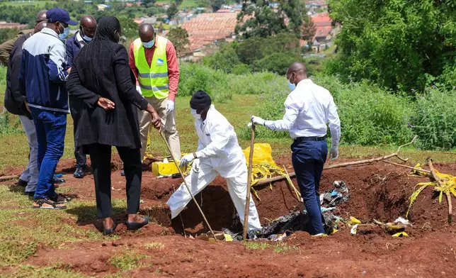Directorate of Criminal Investigations (DCI) forensic staff inspect the scene of a mass grave where 33 bodies were exhumed at a cemetery in Kericho, Western Kenya Thursday, March 26, 2026. (AP Photo/Andrew Kasuku)