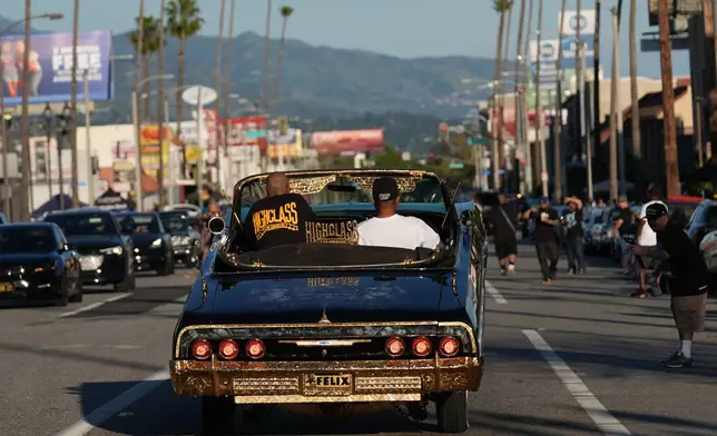 Lowriders cruise at the 6th Annual Lady Lowrider Cruise Night in celebration of International Women's Day in Pasadena, Calif., on Sunday, March 8, 2026. (AP Photo/Damian Dovarganes)
