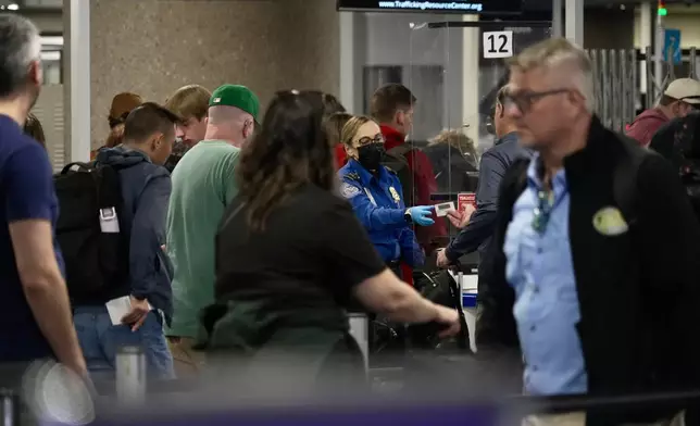 A TSA staff member security walking past a check point at Harry Reid International Airport, Saturday, March 21, 2026, in Las Vegas. (AP Photo/Ty ONeil)