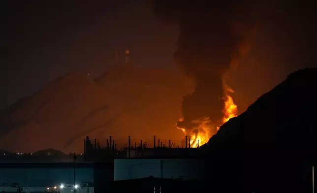 Large fire and plume of smoke is visible after, according to the authorities, debris of an Iranian intercepted drone hit the Fujairah oil facility, in Fujairah, United Arab Emirates, Tuesday, March 3, 2026. (AP Photo/Altaf Qadri)
