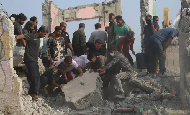 Rescue workers and residents search through the rubble in the aftermath of an Israeli-U.S. strike on a girls' elementary school in Minab, Iran, Saturday, Feb. 28, 2026. (Abbas Zakeri/Mehr News Agency via AP)