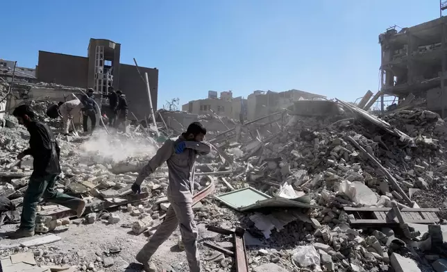 A group of men inspects the ruins of a police station struck Monday amid the U.S.–Israeli military campaign in Tehran, Iran, Tuesday, March 3, 2026. (AP Photo/Vahid Salemi)