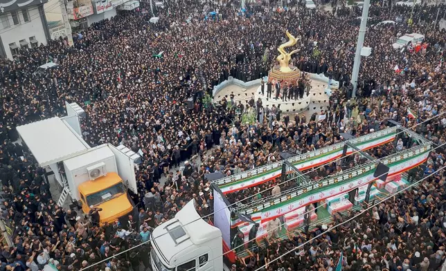 Residents and officials attend the funeral of people killed in what Iranian officials said was an Israeli-U.S. strike Feb. 28 on a girls' elementary school in Minab, Iran, Tuesday, March 3, 2026. (Abbas Zakeri/Mehr News Agency via AP)