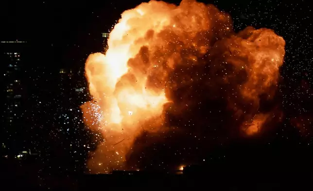 An explosion is seen as an Iranian missile directly hits a building in Tel Aviv, Israel, Saturday, Feb. 28, 2026. (AP Photo/Tomer Neuberg)