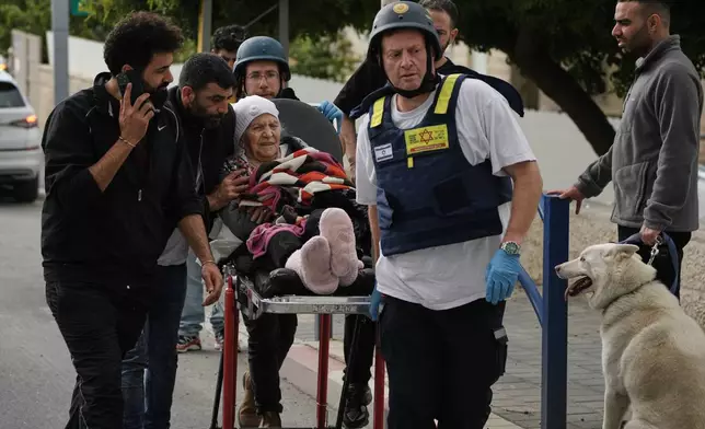Paramedics evacuate wounded people from the site of a deadly Iranian missile strike in Beit Shemesh, Israel Sunday, March 1, 2026. (AP Photo/Leo Correa)