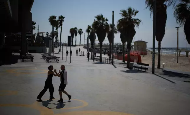 Jack Schneider practices Israeli folk dancing with his partner at the beachfront of Tel Aviv, Israel, Monday, March 2, 2026. (AP Photo/Leo Correa)