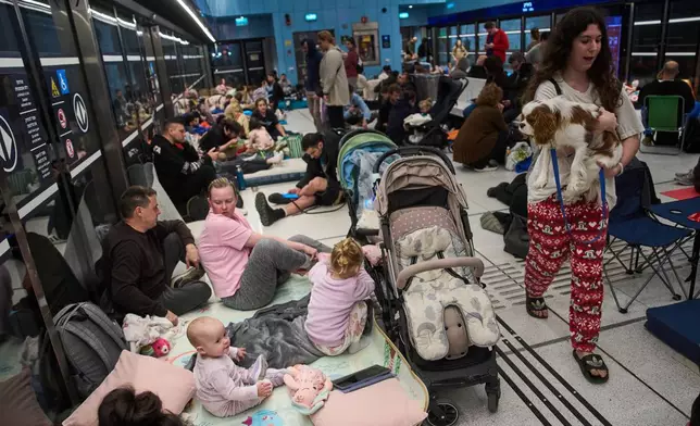 People take shelter in an underground metro station as air raid sirens warn of incoming strikes by Iran, in Ramat Gan, Israel, Saturday, Feb. 28, 2026. (AP Photo/Oded Balilty)