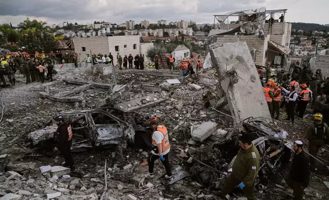 Rescue workers and military personnel operate at the scene where several people were killed in an Iranian missile strike in Beit Shemesh, Israel Sunday, March 1, 2026. (AP Photo/Leo Correa)