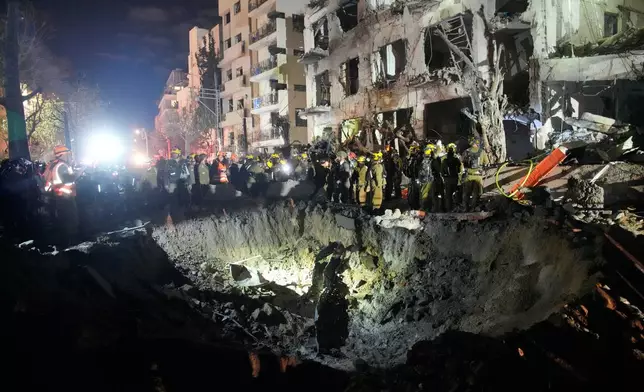 Officers from Israel's Home Front Command search through the rubble of a damaged apartment building after an Iranian missile strike, in Tel Aviv, Israel, early Sunday, March 1, 2026. (AP Photo/Ohad Zwigenberg)
