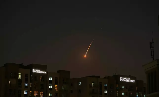 The flare of a projectile is seen over the skyline of Dubai, United Arab Emirates, Saturday, Feb. 28, 2026. (AP Photo/Fatima Shbair)
