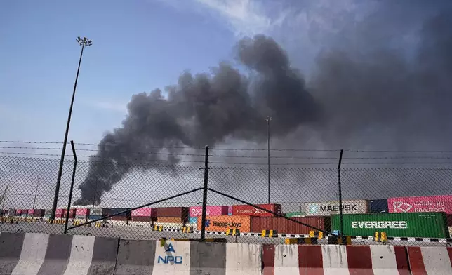 Smoke rises after an Iranian drone attack in the port area of Dubai, United Arab Emirates, Sunday, March 1, 2026. (AP Photo/Fatima Shbair)