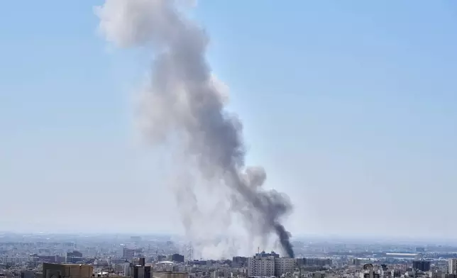 A plume of smoke rises after a strike in Tehran, Iran, Sunday, March 1, 2026. (AP Photo/Vahid Salemi)