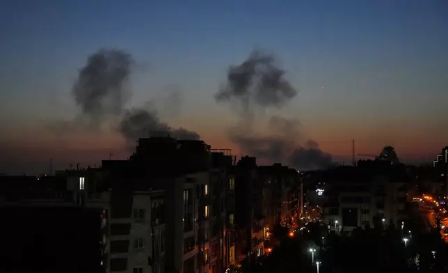 Plumes of smoke rise as strikes hit the city during the U.S.–Israeli military campaign in Tehran, Iran, Friday night, March 6, 2026. (AP Photo/Vahid Salemi)