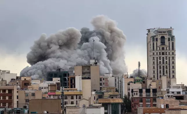 A plume of smoke rises after a strike in Tehran, Iran, Monday, March 2, 2026. (AP Photo/Mohsen Ganji)