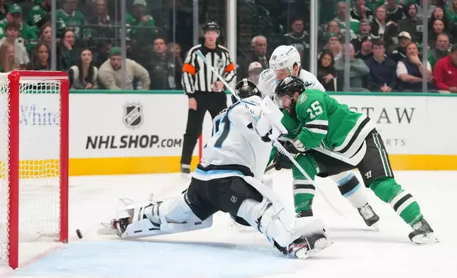 Dallas Stars center Colin Blackwell (15) attacks on the net of Utah Mammoth goaltender Vitek Vanecek during the first period of an NHL hockey game Monday, March 16, 2026, in Dallas. (AP Photo/Julio Cortez)