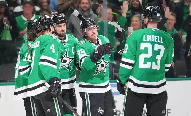Dallas Stars players celebrate a first period goal by center Sam Steel, far left, during an NHL hockey game against the Utah Mammoth Monday, March 16, 2026, in Dallas. (AP Photo/Julio Cortez)