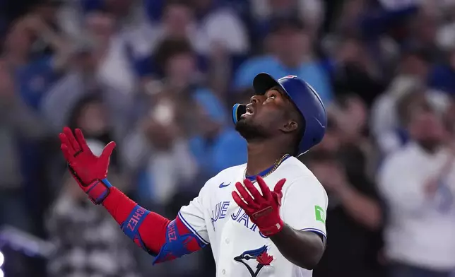 Toronto Blue Jays outfielder Jesús Sánchez reacts at home plate after hitting a two run home run against the Athletics during third inning American League baseball action in Toronto on Sunday, March 29, 2026. (Nathan Denette/The Canadian Press via AP)