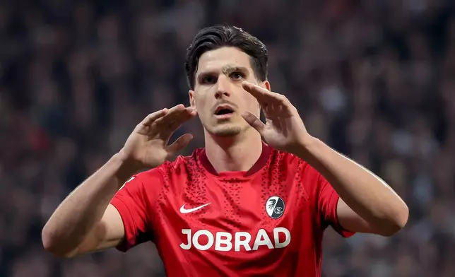 Freiburg's Igor Matanovic celebrates after scoring his side's first goal during the German Bundesliga soccer match between FC St. Pauli and SC Freiburg in Hamburg, Germany, Sunday, March 22, 2026. (Christian Charisius/dpa via AP)