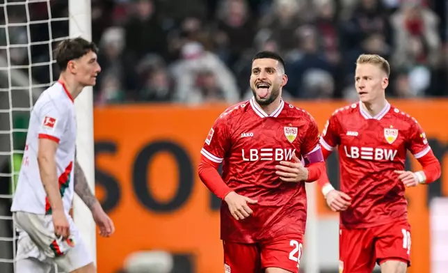 Stuttgart's Deniz Undav, center, celebrates after scoring his side's fourth goal during the German Bundesliga soccer match between FC Augsburg and VfB Stuttgart in Augsburg, Germany, Sunday, March 22, 2026. (Harry Langer/dpa via AP)