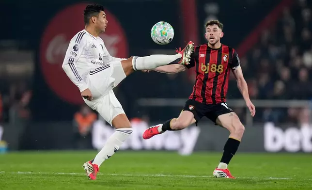 Manchester United's Casemiro, left, controls the ball in front of and Bournemouth's Ryan Christie during an Premier League soccer match, Friday, March 20, 2026, in Bournemouth, England. (Andrew Matthews/PA via AP)