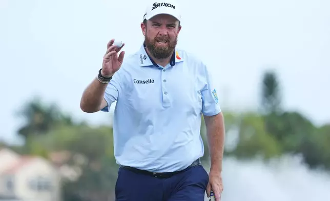 Shane Lowry of Ireland shows his ball on the 18th green during the third round of the Cognizant Classic golf tournament, Saturday, Feb. 28, 2026, in Palm Beach Gardens, Fla. (AP Photo/Marta Lavandier)