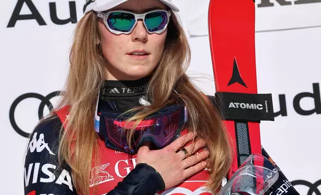 United States' Mikaela Shiffrin listens to the national anthem on the podium after winning an alpine ski, women's World Cup slalom, in Are, Sweden, Sunday, March 15, 2026. (AP Photo/Marco Trovati)