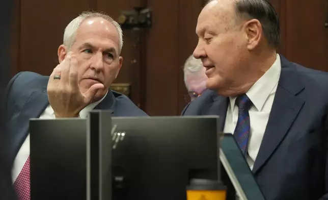 Ex-FirstEnergy Senior Vice President Michael Dowling and former FirstEnergy CEO Chuck Jones talk as they wait for their trial to resume in Summit County Common Pleas Judge Susan Baker Ross's courtroom in Akron, Ohio on Wednesday, March 11, 2026. (Mike Cardew /Akron Beacon Journal via AP, Pool)