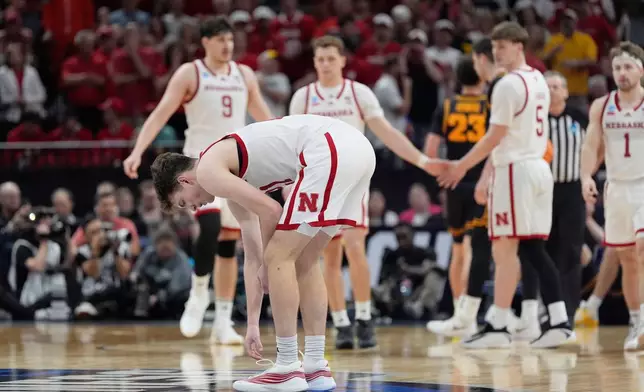Nebraska forward Pryce Sandfort (21), front, reacts after falling during the second half against Nebraska in the Sweet 16 of the NCAA college basketball tournament Thursday, March 26, 2026, in Houston. (AP Photo/Ashley Landis)
