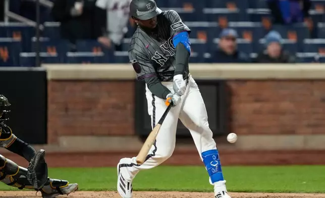 New York Mets center fielder Luis Robert Jr. (88) hits a three run home run during the eleventh inning of a baseball game against the Pittsburgh Pirates, Saturday, March 28, 2026, in New York. (AP Photo/Yuki Iwamura)