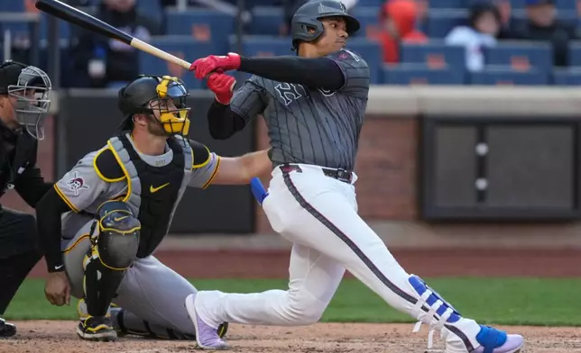 New York Mets' Juan Soto (22) hits a single during the sixth inning of a baseball game against the Pittsburgh Pirates, Saturday, March 28, 2026, in New York. (AP Photo/Yuki Iwamura)