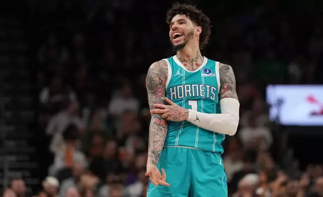 Charlotte Hornets guard LaMelo Ball reacts towards a fan after scoring against the Phoenix Suns during the second half of an NBA basketball game, Sunday, March 8, 2026, in Phoenix. (AP Photo/Rick Scuteri)