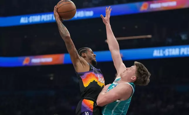 Phoenix Suns guard Jalen Green (4) shoots over Charlotte Hornets guard Kon Knueppel during the first half of an NBA basketball game, Sunday, March 8, 2026, in Phoenix. (AP Photo/Rick Scuteri)