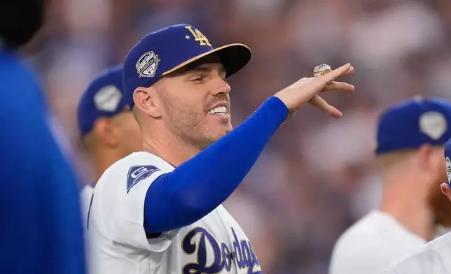Los Angeles Dodgers' Freddie Freeman looks at his ring during a World Series ring ceremony prior to a baseball game against the Arizona Diamondbacks, Friday, March 27, 2026, in Los Angeles. (AP Photo/Mark J. Terrill)