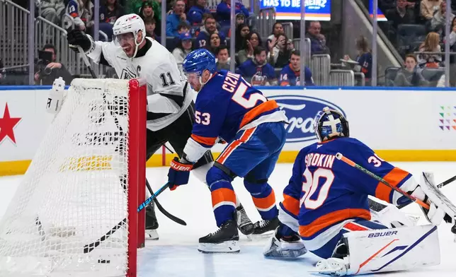 Los Angeles Kings' Anze Kopitar (11) celebrates after scoring a goal during the first period of an NHL hockey game as New York Islanders' Casey Cizikas (53) and goaltender Ilya Sorokin (30) watch Friday, March 13, 2026, at UBS Arena in Elmont, N.Y. (AP Photo/Frank Franklin II)