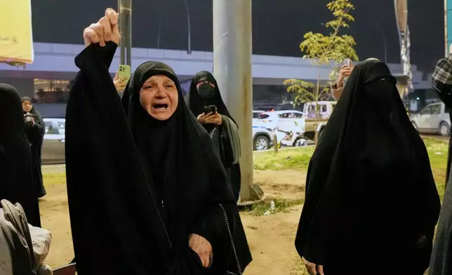 Relatives grieve in Baghdad, Iraq, on Thursday, March 12, 2026, during a funeral for members of the Popular Mobilization Forces who were killed in a U.S. airstrike in Qaim. (AP Photo/Hadi Mizban)