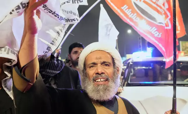 Relatives grieve in Baghdad, Iraq, on Thursday, March 12, 2026, during a funeral for members of the Popular Mobilization Forces who were killed in a U.S. airstrike in Qaim. (AP Photo/Hadi Mizban)