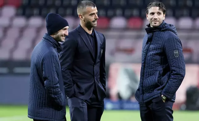 From left to right, Italy's Matteo Politano, Leonardo Spinazzola, and Manuel Locatelli walk on the pitch ahead of Tuesday's World Cup playoff final soccer match against Bosnia, at the Bilino Polje stadium, in Zenica, Bosnia, Monday, March 30, 2026. (AP Photo/Armin Durgut)